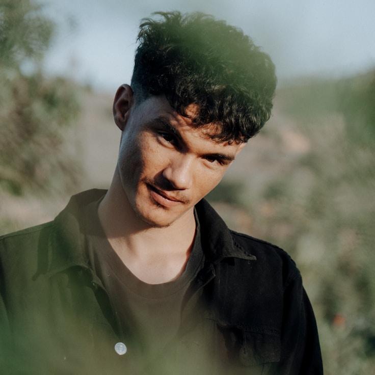 Ava Reed, Lead Design Curator at DawnGardenPath, reviewing corporate floral arrangements